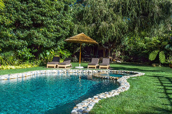 River Rock lined pool with surrounding lawn